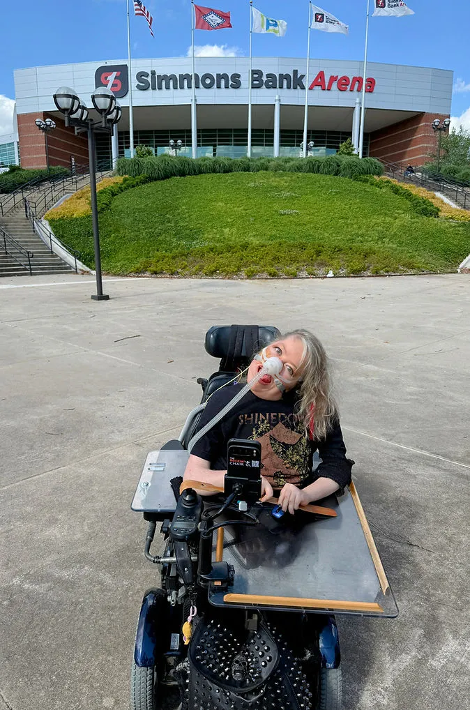 Ashley Franke, founder of The Rockin' Chair, outside Simmons Bank Arena in her wheelchair